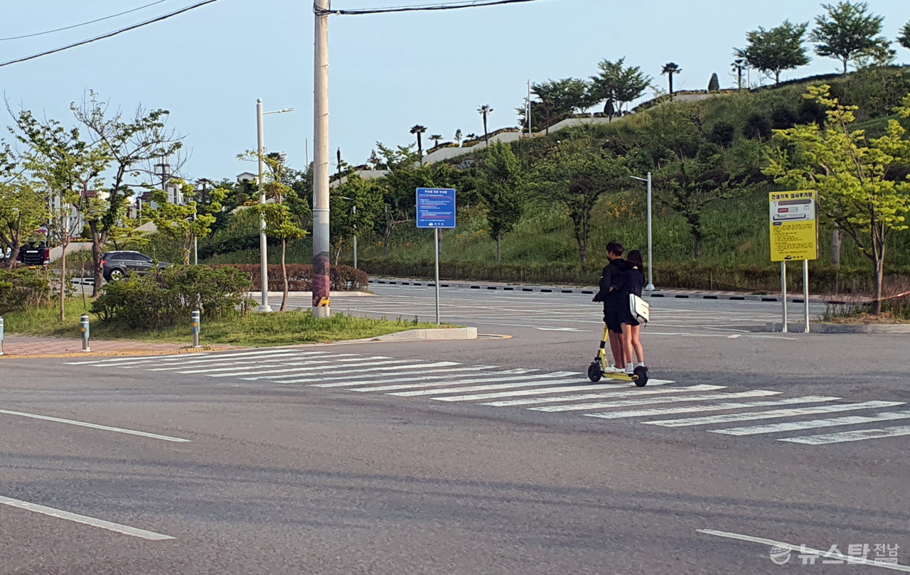 지난 20일 여수시 웅천에서 두 남녀가 헬멧을 쓰지 않고 전동 킥보드를 운전하고 있다. (사진=마재일 기자)